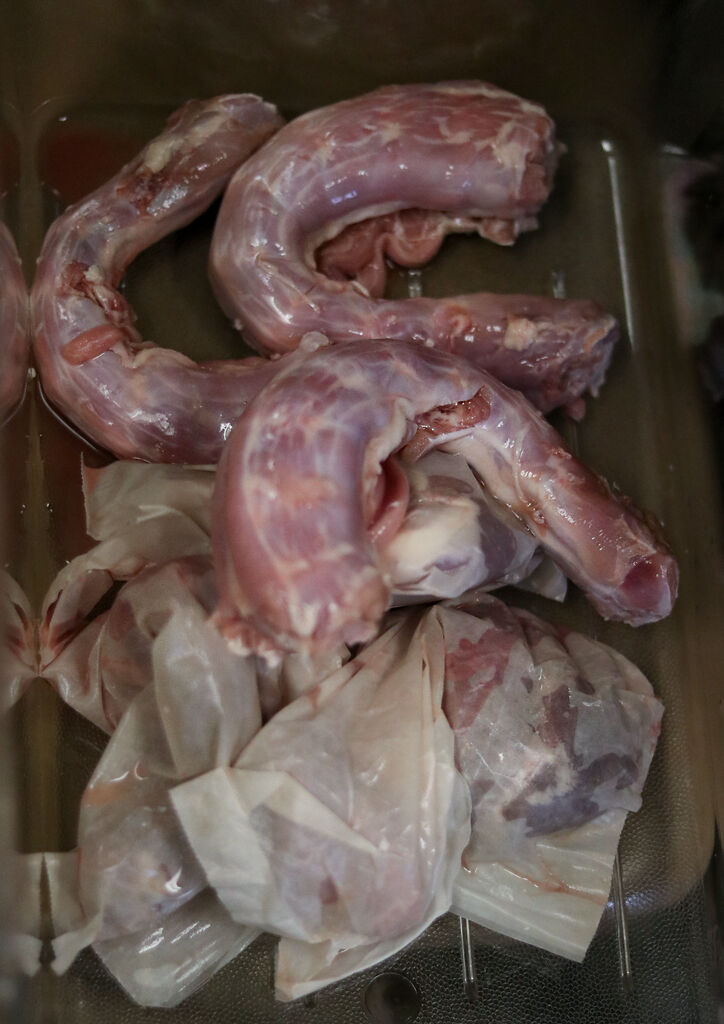 Turkey necks sit in a bin
